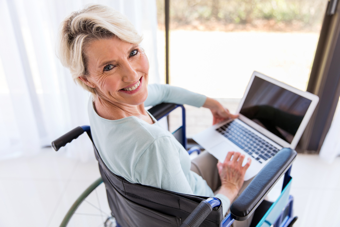 disabled middle aged woman with laptop computer